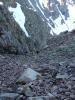 Chris and Alan scramble up a gully on the western side of Maroon Peak's sou...