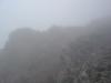 On the way to the summit large crags suddenly appeared out of the mists. Th...